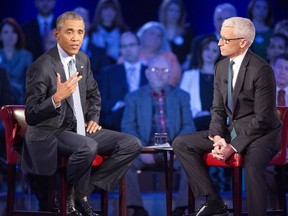 President Barack Obama, left, speaks during a CNN televised town hall meeting hosted by Anderson Cooper, right, at George Mason University in Fairfax, Va., Thursday, Jan. 7, 2016. Obama's proposals to tighten gun controls rules may not accomplish his goal of keeping guns out of the hands of would-be criminals and those who aren't legally allowed to buy a weapon. In short, that's because the conditions he is changing by executive action are murkier than he made them out to be. (AP Photo/Pablo Martinez Monsivais)