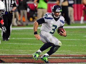 Seahawks quarterback Russell Wilson runs the ball during second half NFL action against the Cardinals in Glendale, Ariz., on Sunday, Jan. 3, 2016. (Matt Kartozian/USA TODAY Sports)
