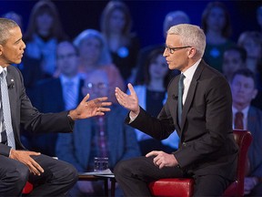 U.S. President Barack Obama, left, during a CNN televised town hall meeting hosted by Anderson Cooper, right, at George Mason University in Fairfax, Va., Thursday, Jan. 7, 2016.  (AP Photo/Pablo Martinez Monsivais)