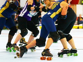 Chinstraps jammer "Slacker" takes a hit during a November bout against the Bath City Roller Girls in Shelby Township, Mich. The Chinstraps, a Sarnia-based roller derby team, is looking for new skaters. Handout/Sarnia Observer/Postmedia Network