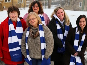 Tim Miller/The Intelligencer
Sandie Sidsworth (front) executive director of the Canadian Mental Health Association Hastings and Prince Edward County (CMHA-HPE) branch shows off one of the 200 scarves donated by the Bell Let's Talk Campaign for this year's Sleep Out So Others Can Sleep In event. Back row from left to right are CMHA-HPE staff members Wendy Danford, Joan Gauthier, Jaime Campbell and Kara Wickens.