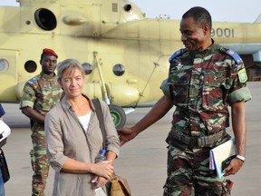 In this file photo taken Tuesday, April 24, 2012, released Swiss hostage Beatrice Stockly, left, arrives by helicopter from Timbuktu, Mali after being handed over by a militant Islamic group Ansar Dine, in Ouagadougou, Burkina Faso. (AP Photo/Brahima Ouedraogo, File)