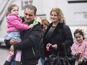 Newly-arrived Syrian refugees meet sponsors and relatives at the Armenian Community Centre in Toronto on Wednesday, December 16, 2015. The federal government appears likely to miss its latest target to resettle 10,000 Syrians by the end of this year. (THE CANADIAN PRESS/Nathan Denette)