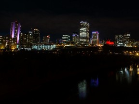 The ATB Financial building is seen lit in the tri colours of the flag of France in Edmonton, Alta., on Saturday November 14, 2015. Ian Kucerak/Edmonton Sun