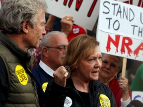Andy, left, and Barbara Parker, centre, whose daughter Alison Parker was shot and killed on air during a live television segment in August, take part in a protest and vigil against gun violence on the third anniversary of the Sandy Hook mass shooting, outside the National Rifle Association (NRA) headquarters in Fairfax, Virginia December 14, 2015. (REUTERS/Jonathan Ernst)