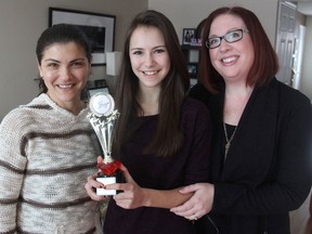 Young actor Alexandra Hook, centre, flanked by her mother Viktoria Koganova, left, and talent agency owner Tammy Godefroy, holds a Joey Award at her home in Kingston on Friday, a national award for her work in television commercials. (Michael Lea/The Whig-Standard)
