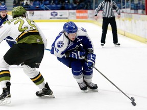 Michael Pezzetta, right, of the Sudbury Wolves, attempts to skate past Mark Shoemaker, of the North Bay Battalion, during OHL action at the Sudbury Community Arena in Sudbury, Ont. on Friday January 8, 2016. John Lappa/Sudbury Star/Postmedia Network
