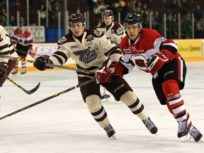 Peterborough Petes defenceman Nick Grima races Ottawa 67's forward Travis Barron to the puck during OHL action at TD Place on Friday, Jan. 8, 2015. (Chris Hofley/Ottawa Sun)