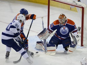 Cam Talbot stops Tampa Bay’s Vladislav Namestnikov during second-period action at Rexall Place on Friday. (Perry Mah, Edmonton Sun)