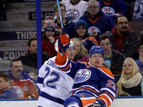 Edmonton Oilers’ Matt Hendricks (23) Tampa Bay’s Erik Condra (22) during first period NHL action at Rexall Place on Friday. (Perry Mah, Edmonton Sun)