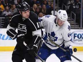 Kings left wing Milan Lucic (left) and Maple Leafs defenceman Morgan Rielly (right) battle for the puck during NHL action in Los Angeles on Thursday, Jan. 7, 2016. (Kelvin Kuo/USA TODAY Sports)