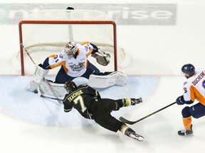 London Knights forward Matthew Tkachuk is tripped by Flint Firebirds defenceman Samuel Duchesne as he attempts to score on Flint Firebirds goaltender Brent Moran during their OHL hockey game at Budweiser Gardens in London, Ont. on Friday January 8, 2016. Craig Glover/The London Free Press/Postmedia Network
