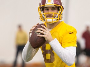 Washington Redskins quarterback Kirk Cousins works on a passing drill during practice at the team's NFL training facility at Redskins Park in Ashburn, Va., on Jan. 8, 2016. (AP Photo/Evan Vucci)