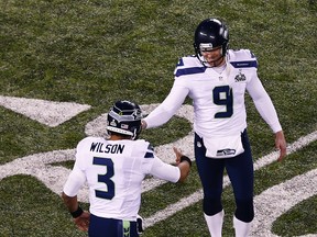 Quarterback Russell Wilson and punter Jon Ryan of the Seattle Seahawks celebrates against the Denver Broncos during Super Bowl XLVIII at MetLife Stadium in East Rutherford, N.J., on Feb. 2, 2014. (Jeff Zelevansky/Getty Images/AFP)