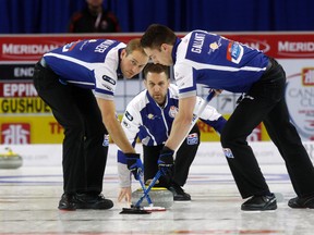 Brad Gushue, middle, watches as Geoff Walker and Brett Gallant sweep during the Home Hardware Canada at Revolution Place in Grande Prairie, Alta., on Dec. 4, 2015. (Logan Clow/Grande Prairie Daily Herald-Tribune/Postmedia Network)