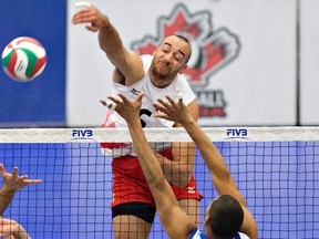 Team Canada's Justin Duff spikes the ball against Puerto Rico on Saturday (Jason Franson, The Canadian Press).