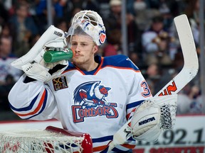 Bakersfield Condors goaltender #31 Laurent Brossoit takes a drink of water during a break in an American Hockey League (AHL) game at the Rabobank Arena in Bakersfield, California on Nov. 28, 2015. The Condors are owned by  Oilers Entertainment Group (OEG). Photo Mark Nessia/Mark Nessia Photography