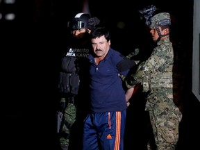 Joaquin "El Chapo" Guzman is escorted by soldiers during a presentation in Mexico City, January 8, 2016. (REUTERS/Tomas Bravo)