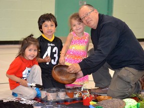 Supplied photo
Ojibwe artist and educator Will Morin plants sweetgrass seeds with St. David School kindergarten students, M'Komii Morin, Ethan McNichol and Sierra Pitawanikwat.