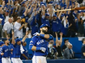 Jose Bautista of the Toronto Blue Jays flips his bat after hitting a three-run homer in the 7th Inning against the Texas Rangers in Game Five of the American League Division Series in Toronto Wednesday, October 14, 2015. (STAN BEHAL/Toronto Sun)
