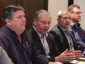 OPSEU president Warren (Smokey) Thomas, centre, along with the bargaining unit announces an agreement has been reached in contract talks with the government of Ontario on Saturday, January 9, 2016. (Veronica Henri/Toronto Sun)