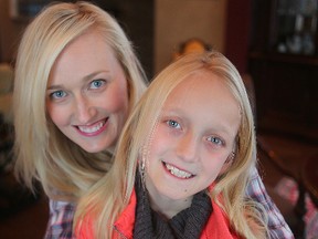 Shaleen Davidson, left, hugs her nine-year-old daughter Asia in Winnipeg, Man. Sunday, Jan. 10, 2016. Asia used her birthday money to purchase 50 blankets for Red River Lodge. (Brian Donogh/Winnipeg Sun/Postmedia Network)