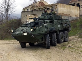 Lieutenant-Colonel Craig King, Commander of the First Battalion Princess Patricia's Canadian Light Infantry (1 PPCLI) Battle Group, in his Light Armoured Vehicle III (LAV III) drives a patrol along a road near Zgon, Bosnia-Herzegovina. (MCpl Paul MacGregor/DND)