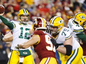 Green Bay Packers quarterback Aaron Rodgers (12) throws the ball over Washington Redskins outside linebacker Ryan Kerrigan (91) during the first half in a NFC Wild Card playoff football game at FedEx Field. Geoff Burke-USA TODAY Sports