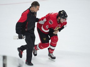 Ottawa Senators right wing Bobby Ryan is helped off the ice by team staff after crashing into the boards during NHL action against the Boston Bruins Saturday January 9, 2016 in Ottawa. The Senators defeated the Bruins 2-1 in overtime. THE CANADIAN PRESS/Adrian Wyld