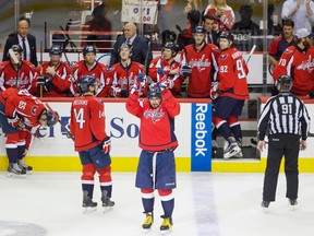 Washington Capitals left wing Alex Ovechkin (8), of Russia, acknowledges the fans in celebration as he comes back out of the box to a standing ovation after Ovechkin scored his 500th career NHL goal during the second period of a hockey game against the Ottawa Senators in Washington, D.C., Sunday, Jan. 10, 2016. (AP Photo/Jacquelyn Martin)
