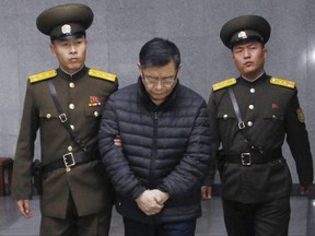 Hyeon Soo Lim, centre, who pastors the Light Korean Presbyterian Church in Toronto, is escorted to his sentencing in Pyongyang, North Korea, last month.(AP PHOTO)