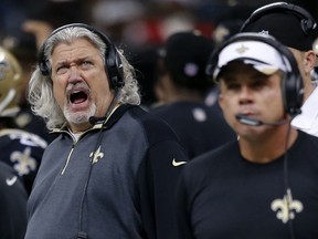 In this photo taken on Dec. 21, 2014, New Orleans Saints defensive coordinator Rob Ryan, left, yells behind head coach Sean Payton, right, in the second half of an NFL football game in New Orleans. Rex Ryan isn't the only member of the Ryan family working with the Buffalo Bills this week. Rob Ryan, Rex Ryan's twin brother, has been spending time at Bills practices as Buffalo prepares for Sunday's game against Philadelphia. Rob Ryan was fired as defensive coordinator of the New Orleans Saints in mid-November and has been spotted leaving the practice field with the team on Wednesday, Dec. 9, 2015, and Thursday, Dec. 10 dressed in full Bills attire.  (AP Photo/Bill Haber, File)