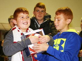 Nabil Qarqouz admires the soccer ball his brother Osama received at a reception following a worship service at St. Andrew's United Church earlier this year. The boys now have new younger brother, born just a few days ago on Canadian soil. (Gino Donato/Sudbury Star file photo)