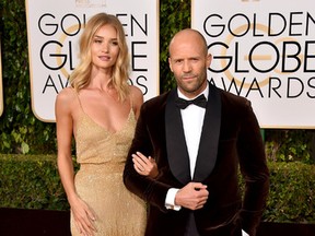 Rosie Huntington-Whiteley, left, and Jason Statham arrive at the 73rd annual Golden Globe Awards on Sunday, Jan. 10, 2016, at the Beverly Hilton Hotel in Beverly Hills, Calif. (Photo by Jordan Strauss/Invision/AP)