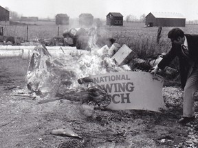 Frank Vercouteren examines the remains of TOBE-COBE on December 2, 1980, after someone had set it on fire.
