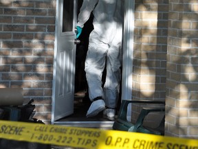 This Intelligencer file photo from 2012 shows OPP forensic identification officers entering the Adrian Court apartment where Cindy Sullivan was found dead.