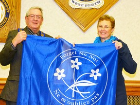 In recognition of Alzheimer’s Awareness Month in January, West Perth Mayor Walter McKenzie and Sheri Gilhula, the public education coordinator for the Alzheimer Society of Perth County, performed the ceremonial Alzheimer Society flag raising in the council chambers before the Dec. 21 West Perth council meeting. GALEN SIMMONS/MITCHELL ADVOCATE