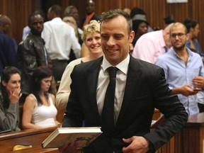 Oscar Pistorius, center, leaves a courtroom of the High Court in Pretoria, South Africa, Tuesday Dec. 8, 2015. Judge Aubrey Ledwaba granted Pistorius bail and extended his house arrest for the murder conviction of his girlfriend Reeva Steenkamp until April 18 2016. (AP Photo/Siphiwe Sibeko, Pool)