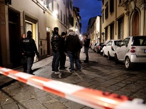 Italian police officers stand outside an apartment where 35-year-old American woman Ashley Olsen was found dead, in Florence, Italy, Saturday, Jan. 9, 2016. Italian police say the woman has been found slain in her apartment with bruises and scratches on her neck, but wouldn’t comment on Italian news reports that the woman had been strangled until an autopsy is performed. (Maurizio Degl'Innocenti/ANSA via AP)