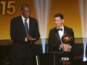 FC Barcelona's Lionel Messi receives the 2015 FIFA Ballon d'Or for the world player of the year as FIFA acting President Issa Hayatou (left) applauds during an awards ceremony in Zurich, Switzerland, on Monday, Jan. 11, 2016. (Arnd Wiegmann/Reuters)