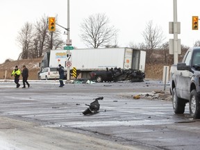 Two pickup trucks collided at Veterans Memorial Parkway and Bradley Avenue Monday afternoon. After the collision, the one truck was forced into the path of a semi, which ran over it. Two people taken to hospital, one man had to be extricated and has with life-threatening injuries. (MIKE HENSEN, The London Free Press)