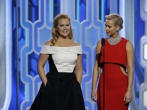 Amy Schumer (L) and Jennifer Lawrence present at the 73rd Golden Globe Awards in Beverly Hills, California January 10, 2016. REUTERS/Paul Drinkwater/NBC Universal/Handout