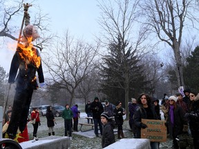 An image of Sir John A Macdonald is burned in effigy by the Idle No More protest group during his 201st birthday celebration on Monday at City Park in Kingston. (Ian MacAlpine/The Whig-Standard)