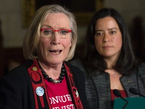 Minister of Justice and Attorney General of Canada Jody Wilson-Raybould looks on as Minister of Indigenous and Northern Affairs Carolyn Bennett responds to a question during an announcement for a Missing and Murdered Indigenous Women inquiry during a news conference in the Foyer of the House of Commons Tuesday December 8, 2015 on Parliament Hill in Ottawa. THE CANADIAN PRESS/Adrian Wyld