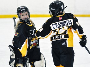 Grace Kipfer (left) of the Mitchell Novice girls hockey team celebrates with cousin Rylee Kipfer during action last fall after a victory. Kipfer was sharp as she recorded three straight shutouts in the recent Exeter tournament. ANDY BADER/MITCHELL ADVOCATE