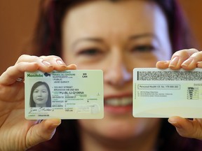 Manitoba Health Minister Sharon Blady displays examples of the new personal identification card at a press conference on Monday. (Brian Donogh/Winnipeg Sun)