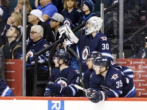 Jets players watch from the bench as the seconds tick down at the end of a 4-2 loss to the lowly Sabres on home ice Sunday.