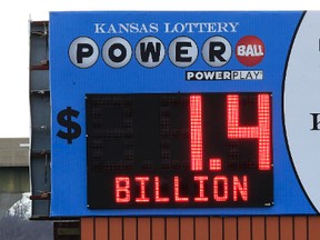 A tractor-trailer passes under a Kansas Lottery billboard in Topeka, Kan., Monday, Jan. 11, 2016. The Powerball jackpot has grown to over 1 billion dollars. (Orlin Wagner/AP)