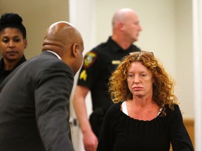 Tonya Couch, front right, heads to the defense table before her bond reduction hearing Monday, Jan 11, 2016, in court in Fort Worth, Texas. Couch, the mother of a Texas teenager who used an "affluenza" defence for a deadly wreck, will soon leave jail after a judge on Monday sharply reduced her bond. (David Kent/Star-Telegram via AP, Pool)