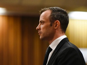 Oscar Pistorius pauses in the dock at the High Court in Pretoria, South Africa, Tuesday Dec. 8, 2015.Pistorius has appealed his murder conviction for killing girlfriend Reeva Steenkamp to South Africa's constitutional Court, a lawyer for the double-amputee Olympian said Monday. THE CANADIAN PRESS/AP/Herman Verwey, Pool